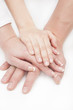 father's, mother's and child's hands together