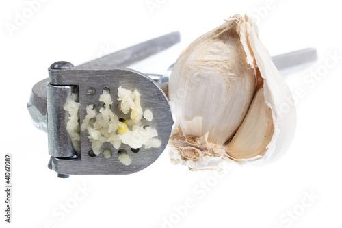 Photo: Garlic Press isolated against white Garlic Press isolated against white