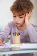 Girl with a pot of crayons