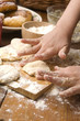 Detail of hands kneading dough