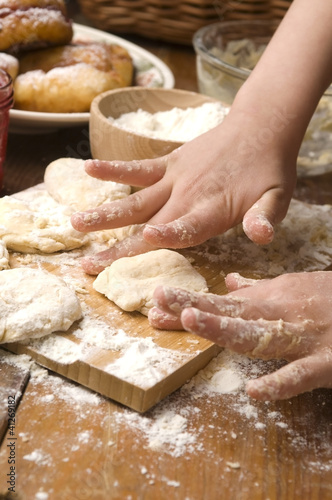 Photo: Detail of hands kneading dough Detail of hands kneading dough