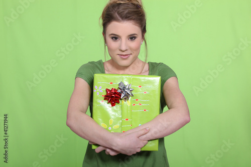 Photo: Woman in green with a green present Woman in green with a green present