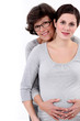 Mother stood with pregnant daughter