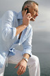 Man admiring the coastal view whilst making a telephone call