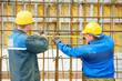 two construction workers making reinforcement