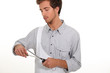 Young man sharpening knife