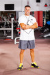 handsome male gym trainer portrait inside gym