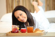 Woman having breakfast in bed