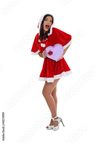 Photo: Young woman in a saucy Santa outfit Young woman in a saucy Santa outfit