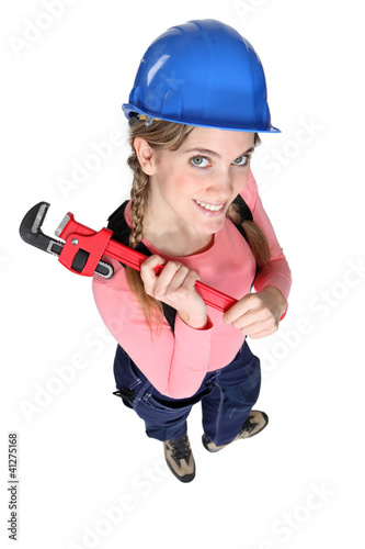 Photo: Happy female worker holding wrench Happy female worker holding wrench