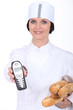 Female baker showing phone