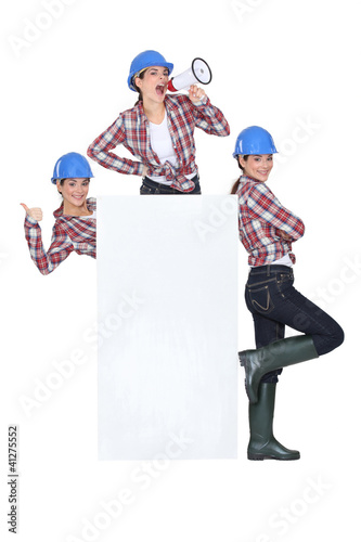 Photo: trio of girls wearing blue hard hat trio of girls wearing blue hard hat