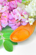 honey in a wooden spoon with acacia flowers