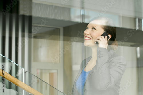 Photo: Business woman using a mobile phone Business woman using a mobile phone