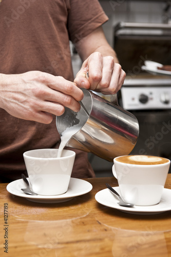 Photo: barista pouring milk barista pouring milk
