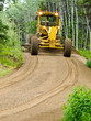 Grader resurfacing narrow rural road