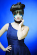Foto: brunette with creative make up in blue dress brunette with creative make up in blue dress