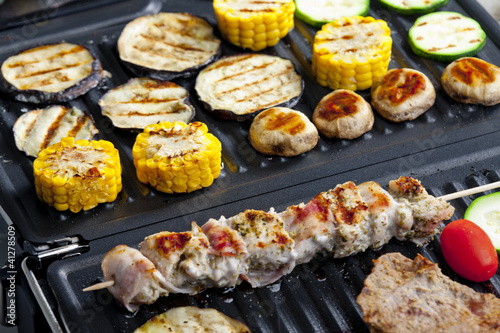 Photo: meat skewer and vegetables on electric grill meat skewer and vegetables on electric grill