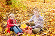 brother and sister in autumn garden
