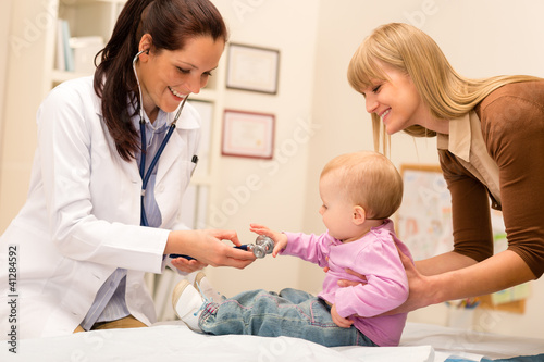 Photo: Pediatrician examine baby with stethoscope Pediatrician examine baby with stethoscope