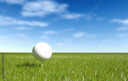 Photo: Golf ball green grass and blue sky Golf ball green grass and blue sky