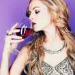 Beautiful blond woman with glass red wine