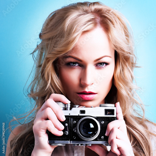 Photo: beautiful blond photographer woman holding retro camera beautiful blond photographer woman holding retro camera