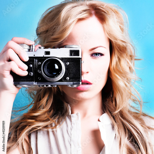 Photo: beautiful blond photographer woman holding retro camera beautiful blond photographer woman holding retro camera
