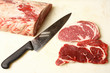 Raw meat with a knife and cut pieces of meat