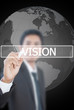 Businessman write Vision word on the whiteboard.