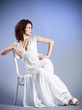 Young woman in retro bridal dress on blue background. Young woman in retro bridal dress on blue background.