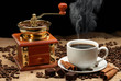 Grinder and a cup of coffee.
