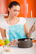Beautiful young woman cooking in the kitchen