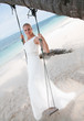 Beautiful bride  swinging on tropical sea side background