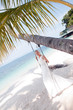 Beautiful bride  swinging on tropical sea side background