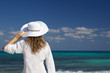 Photo: Woman with a white hat looking at the sea Woman with a white hat looking at the sea