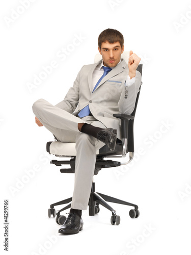 Photo: young businessman sitting in chair young businessman sitting in chair