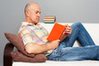 elderly man with interesting book
