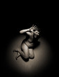 Scared naked man on the ground