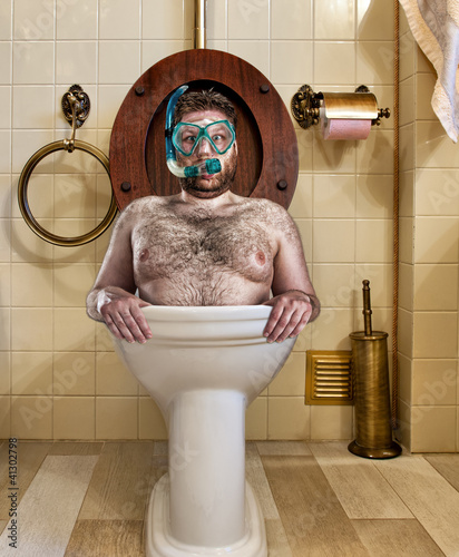 Photo: Bizarre man in vintage toilet Bizarre man in vintage toilet