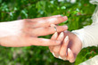 Hands of the groom and the bride with wedding rings