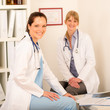 Two female doctor sitting surgery office