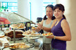 women takes  pastry  in buffet