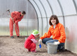 Happy family works in greenhouse Happy family works in greenhouse
