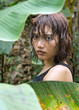 girl hidden between leaf in jungle.