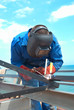 Welder working with metal construction