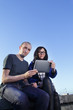 beauty girl and boy with tablet pc outdoors