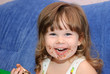 The little girl eats a cake