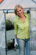 Gardening - woman working in greenhouse Gardening - woman working in greenhouse