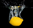 fresh lemon dropping into water fresh lemon dropping into water